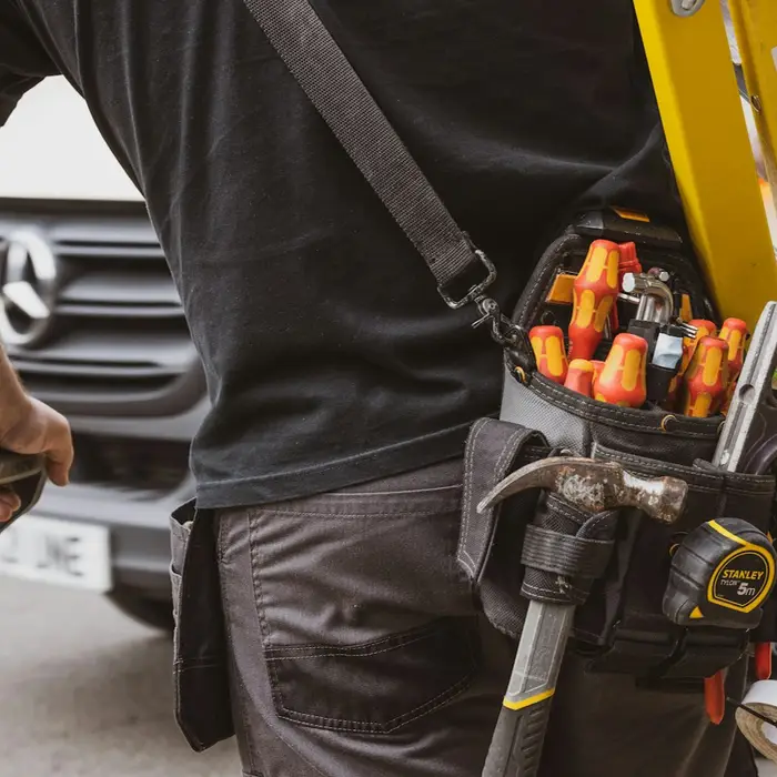 Field technician wearing a tool belt